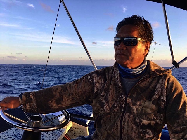 Captain Armelio Cabatingan at the helm on open water