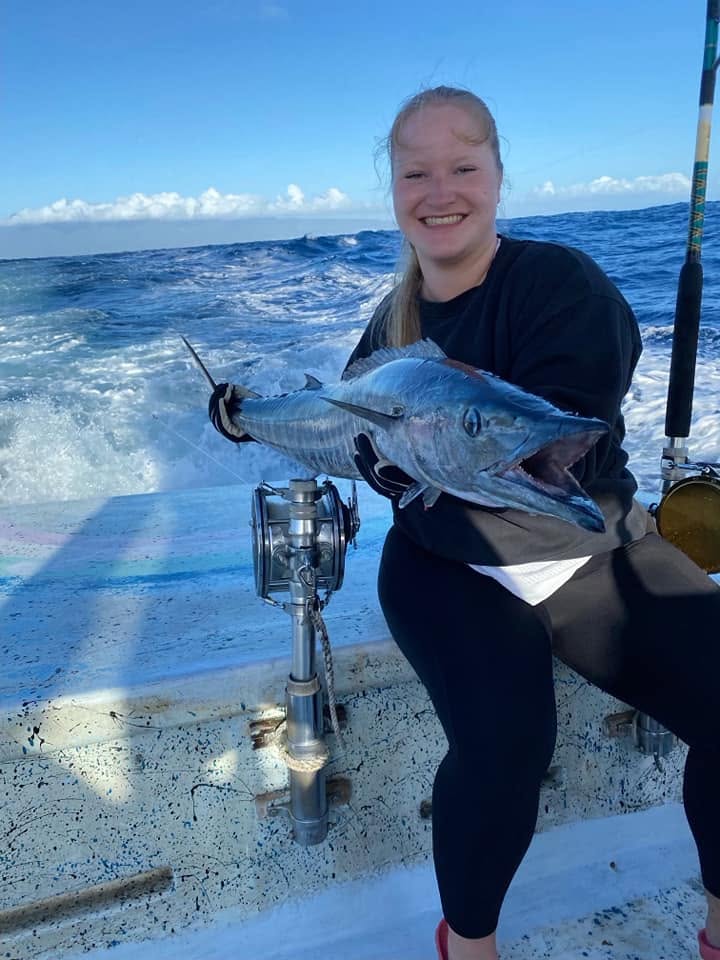 Guest holding a catch while Rainbow Runner is underway