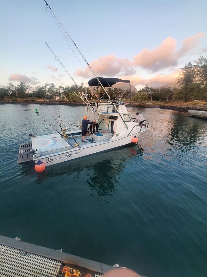 Rainbow Runner in Kahului Harbor beneath pink evening clouds