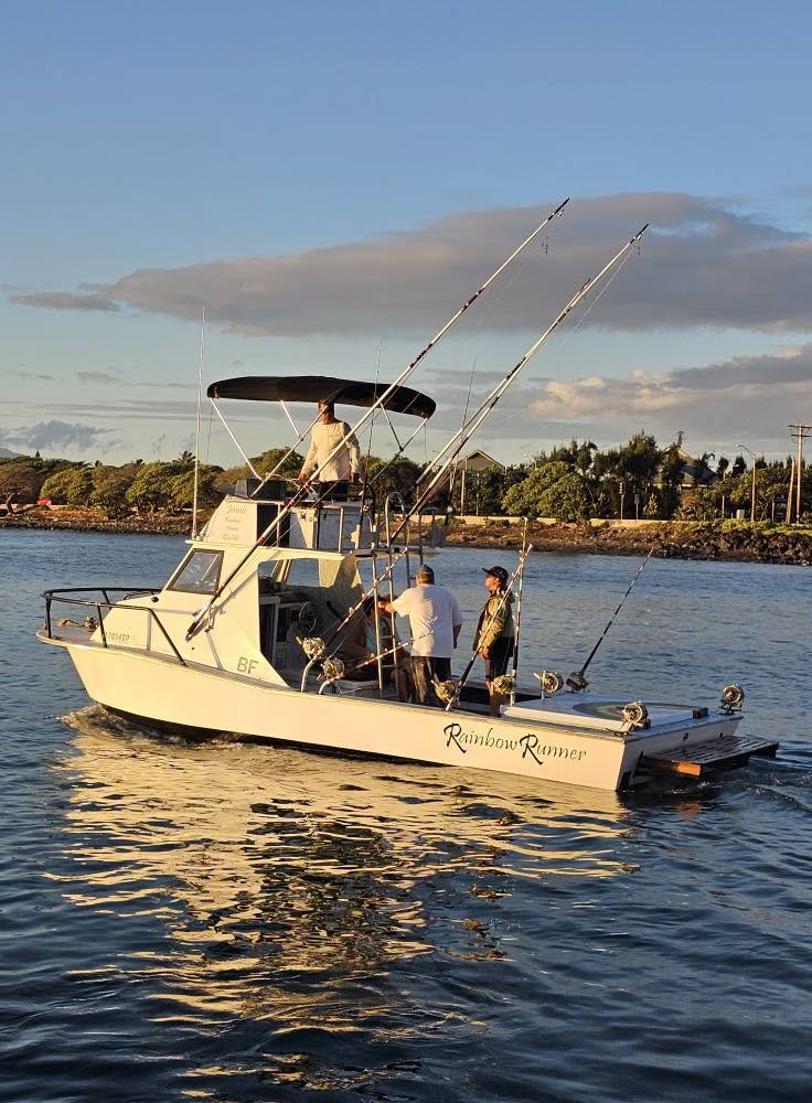 Rainbow Runner moving through Kahului Harbor in warm evening light