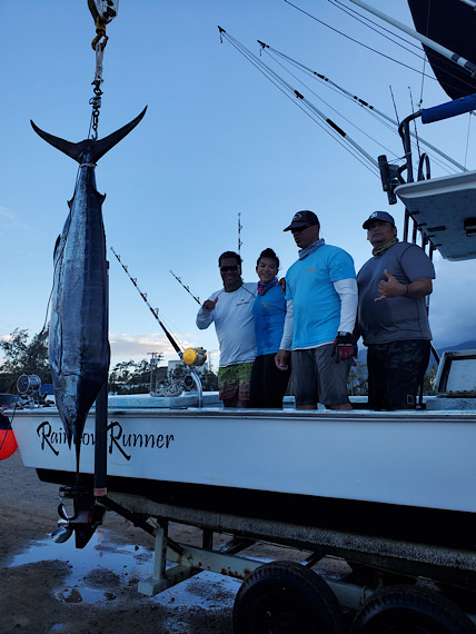 Rainbow Runner crew beside a hanging marlin after the 2020 Hana Paʻa tournament