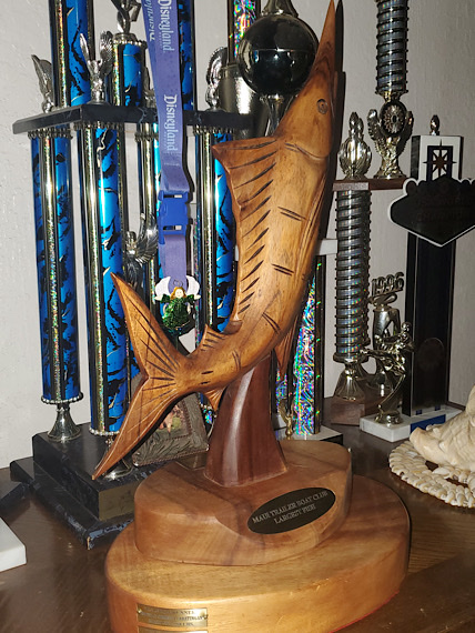 Maui Trailer Boat Club perpetual marlin trophy displayed with other fishing awards