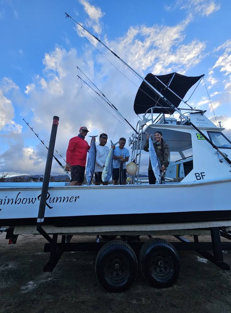 Rainbow Runner on its trailer with four people displaying their catch
